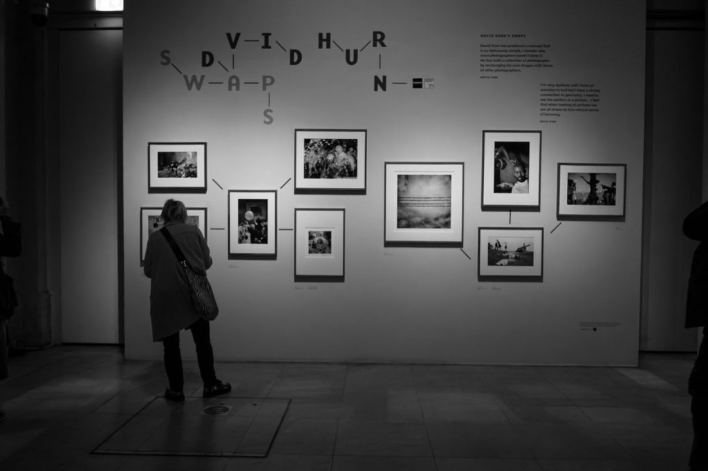 travel photography - travel photograher - images from a visit to photo london this one in monochrome showing visitors to the david hern swoops exhibition