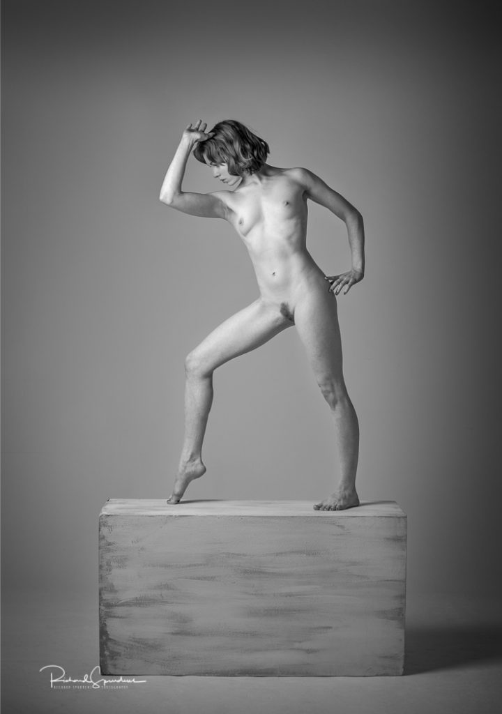 Fine Art Nude Photography - Fine Art Nude Photographer - monochrome image showing a stong artistic nude figure shape standing on a plinth