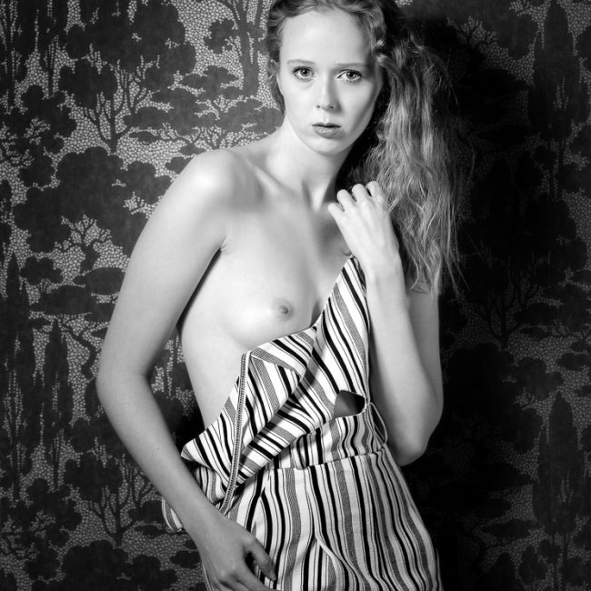 fashion photographer - fashion photography - monochrome image of the model wearing a striped jump straps off the shoulder