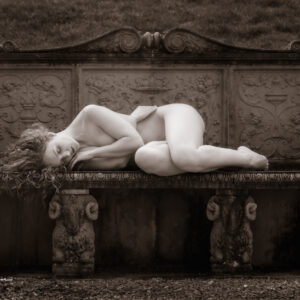 Fine Art Nude Photography - Fine Art Nude Photographer - july print of the month is a monochrome image featuring a figure study of model ivory flame lying across a stone bench which is supported by four rams carved in stone