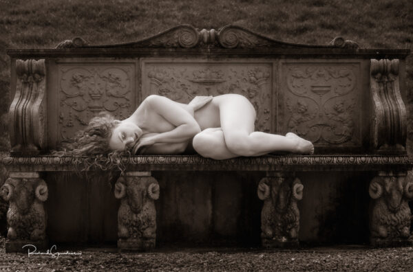 Fine Art Nude Photography - Fine Art Nude Photographer - july print of the month is a monochrome image featuring a figure study of model ivory flame lying across a stone bench which is supported by four rams carved in stone