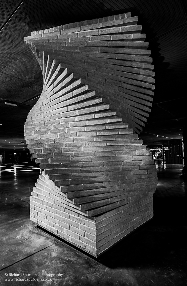 travel photography - travel photographer - monochrome image of a decortive brick support pillar under a building in spain