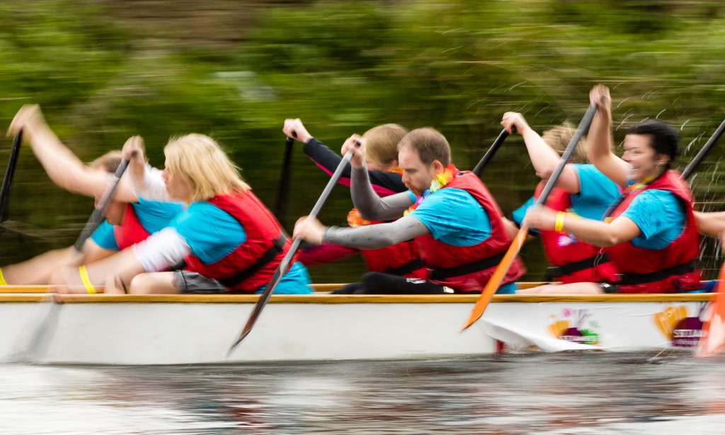 sport photography - sport photographer -colour image of dragon boat racing on the river aire at roberts park saltaire, a slow shutter speed was used together with panning to give a feel of the speed