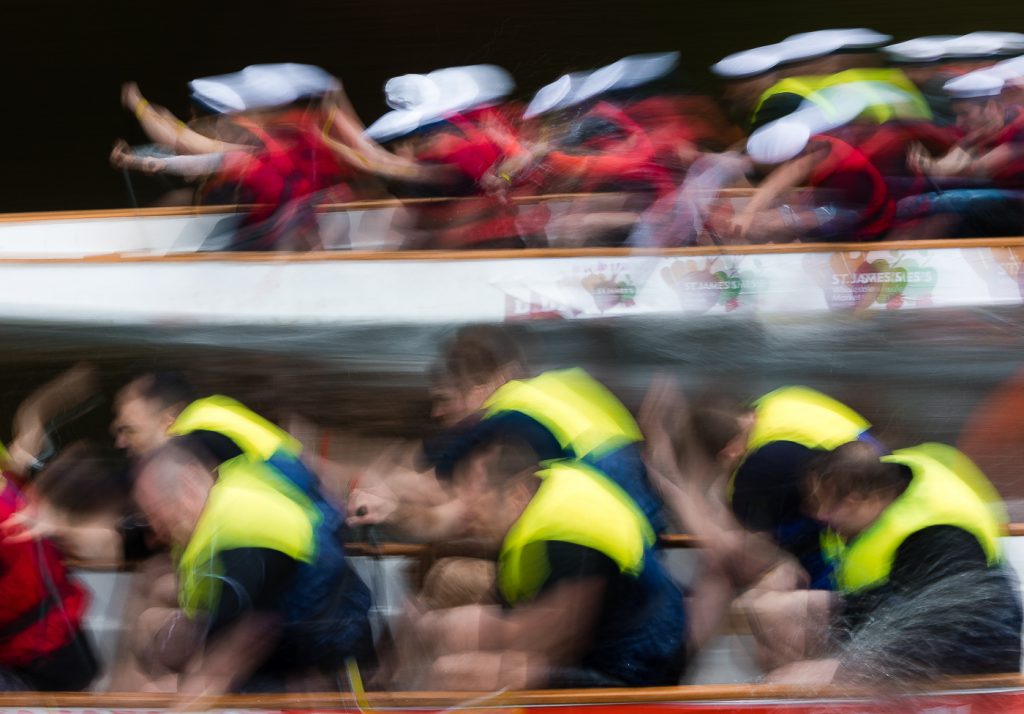 sport photography - sport photographer -colour image of dragon boat racing on the river aire at roberts park saltaire, slow shutter speed was used to give an abstract effect