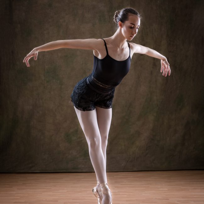 Dance Photographer - Dance photography - image showing dancer Erica M standing on pointe holding her arms out to her side to make a graceful shape