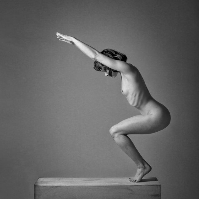 Fine Art Nude Photography - Fine Art Nude Photographer - monochrome image showing a stong artistic nude figure shape standing on a plinth