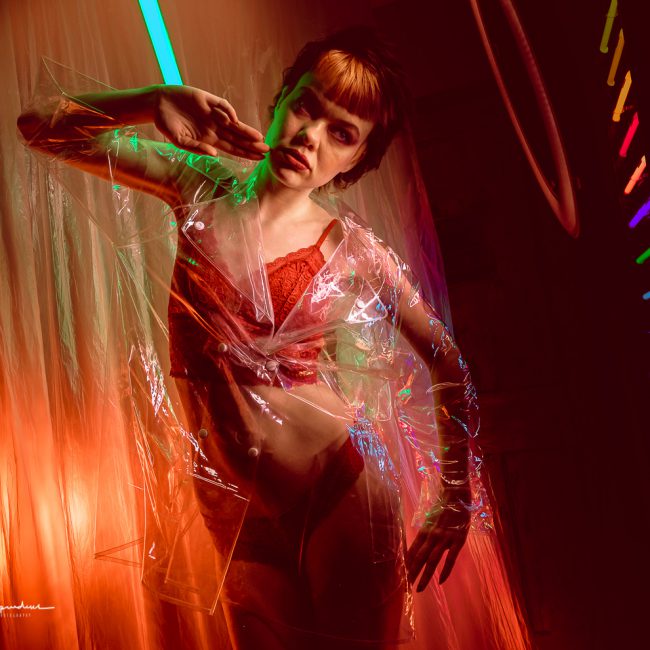 Fashion photographer - Fashion photography - colour image from electic dreams model wears a clear plasticmack and shor using neon lights - highlights 2019