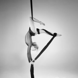 may print of the month - is a monochrome image of aerialist fanny muller using the silks to hang upside down stronge figure shapes using the body and silks