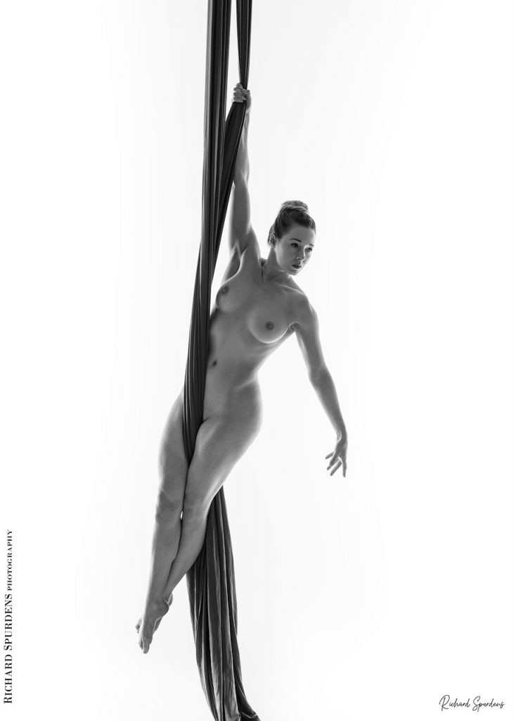 Aerial Arts photographer - Aerial Arts photography - Aerial silks photography - aerialist using hanging silks to make strong hanging shapes just using arm and feet strenght