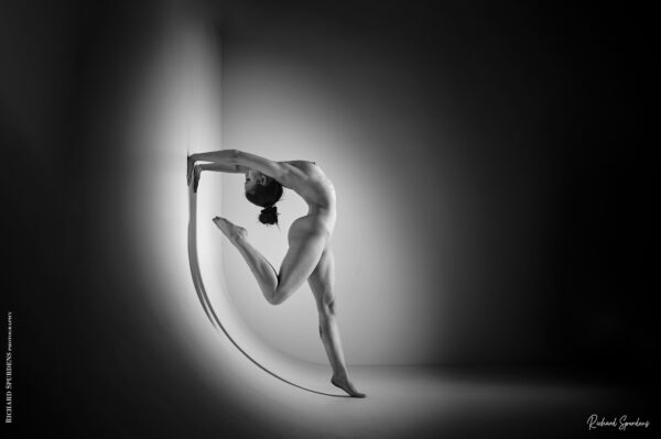 artistic nude photography- artistic nude photographer - model making a back bend against the wall curve