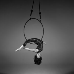 aerial arts photography - aerial arts photograher - monochrome image of aerial artist hang upside down in the splits the hoop