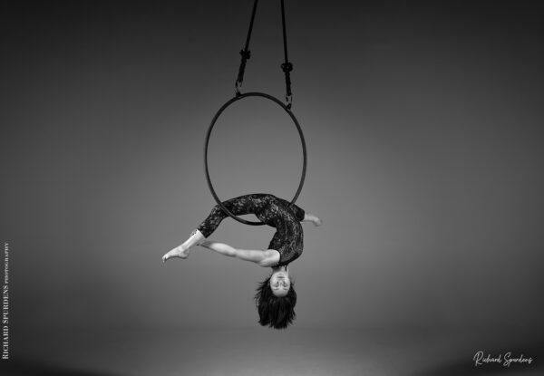 aerial arts photography - aerial arts photograher - monochrome image of aerial artist hang upside down in the splits the hoop