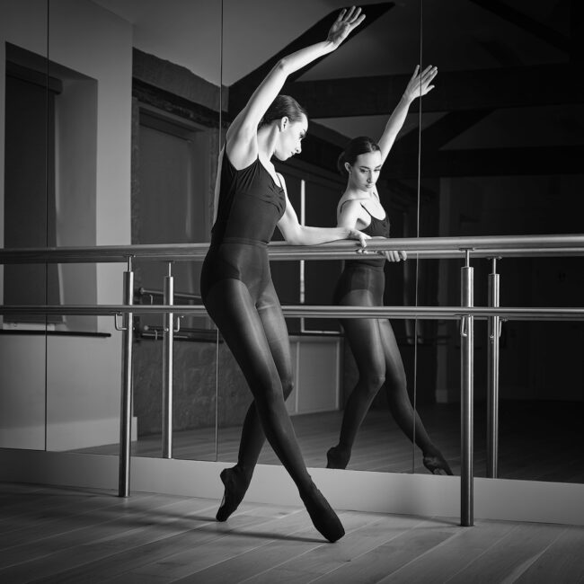 dance photographer - dance photography - dancer working with the barres and her reflection in mirror