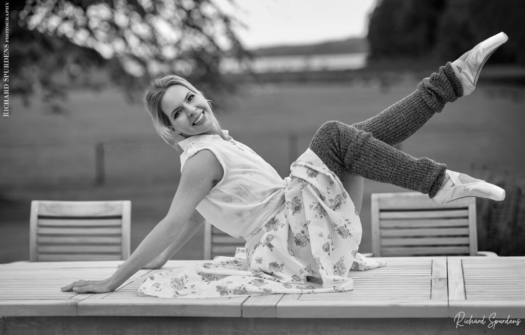 dance photographer - dance photography - outdoor dance moves with dancer seated on a large outdoor table