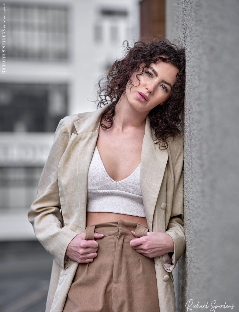 fashion photography fashion photographer - model ahsleigh ray natural light shot of model leaning against a wall look towards the camera