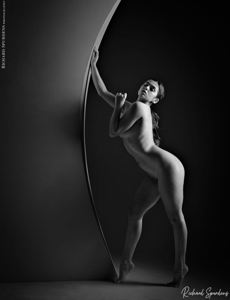 fine art nude photography- fine art nude photographer - featuring model Natalia creating an artistic nude  shapes on a curved wall