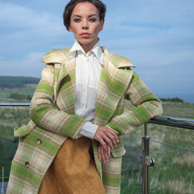 fashion photography fashion photographer - model wearing a green checked coat and brown check skirt