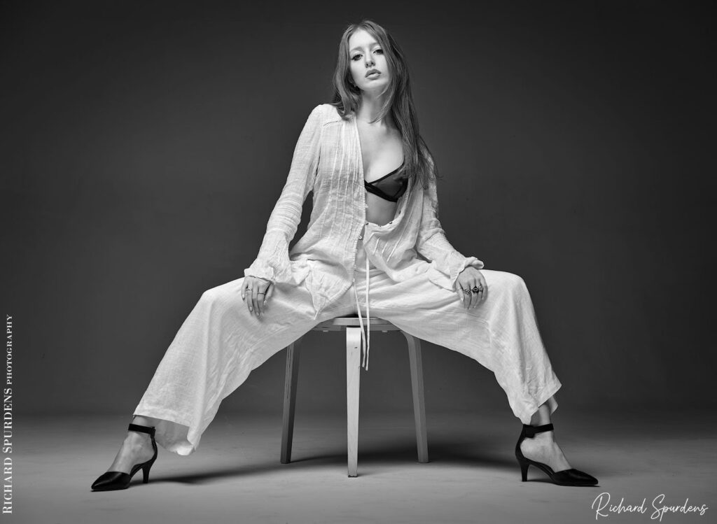 fashion photography fashion photographer  model wearing linen summer trousers and top with black bra.