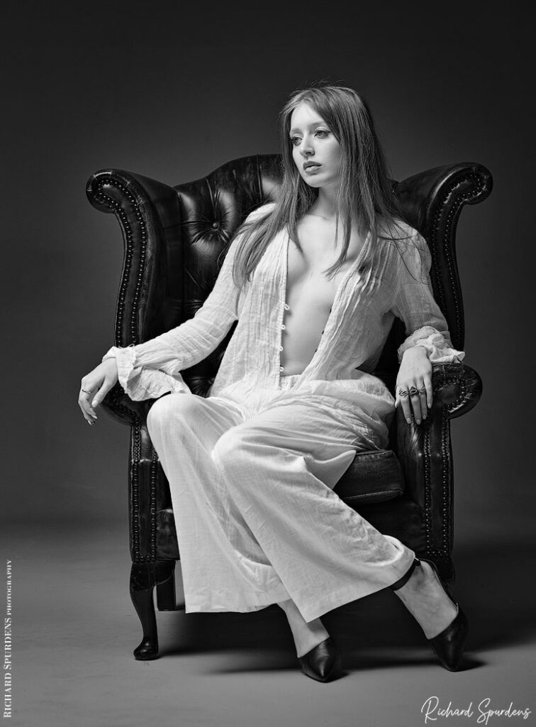 fashion photography fashion photographer - Caitlyn studio session -  model wearing linen summer trousers and top seated in an arm chair