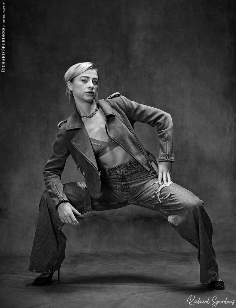 fashion photography - fashion photographer - Crystal fashion fun model wearing leather jacket and torn jeans wide leg squat