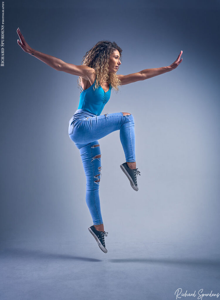 dance photographer - dance photography - dancer creating strong dance shapes as she leaps off the ground