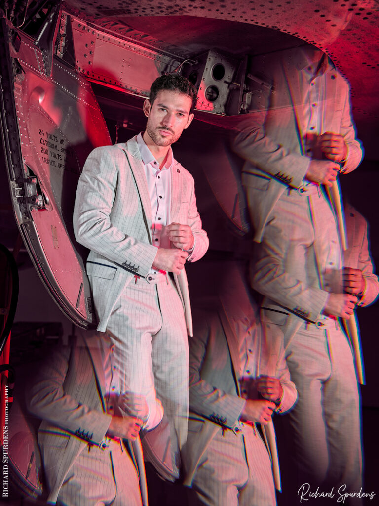 fashion photography fashion photographer - male model Marco wearing a white pin strip suit and shot with a half prism to produce a multiple look